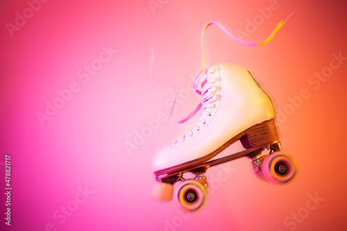 White roller skate on the pink and orange background - pop art poster.