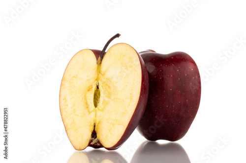 Two halves of a ripe red apple, close-up, isolated on white.