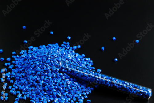Blue granules of polypropylene, polyamide in a test tube. Background. Plastic and polymer industry. Microplastic products.