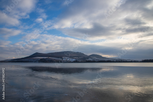 Winter landscape. View of the frozen lake Musov. In the background are the hills of Palava.