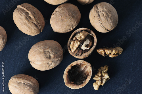 walnuts in a shell on a wooden background - top view