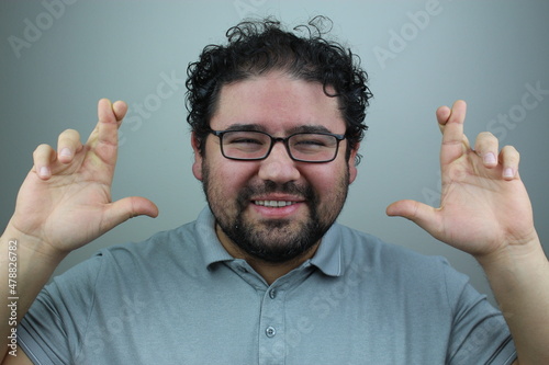 happy young man crossing his fingers