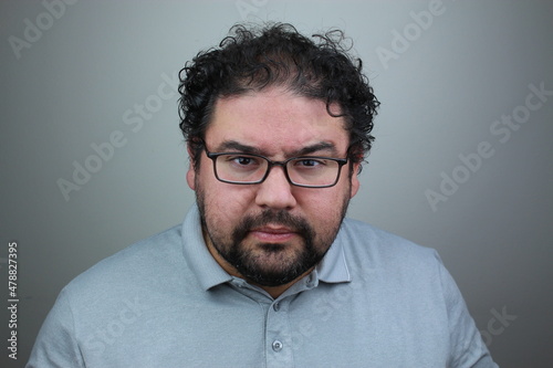emotional portrait of aggressive man on a gray background