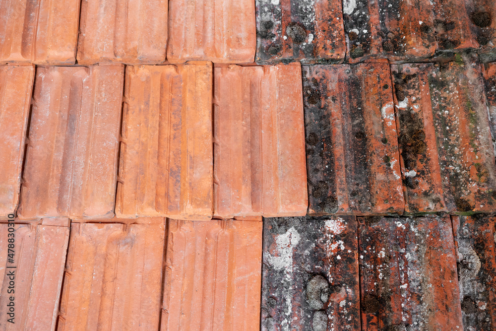 Close up photography of half cleaned roof tiles. Washed tiles and tiles covered with dirt. Close up photography of half cleaned roof tiles. Washed tiles and tiles covered with dirt.