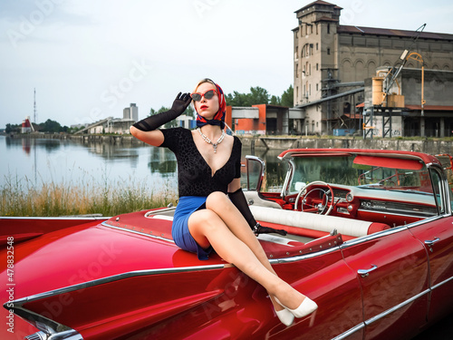 Old-timer red Cadillac and a beautiful young girl