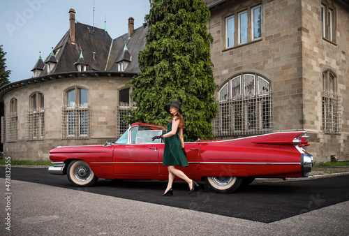 Fotografie, Obraz Old-timer red Cadillac and a beautiful young girl