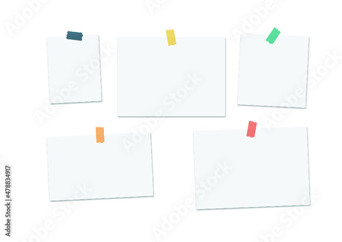 White paper pieces attached to the wall with tape