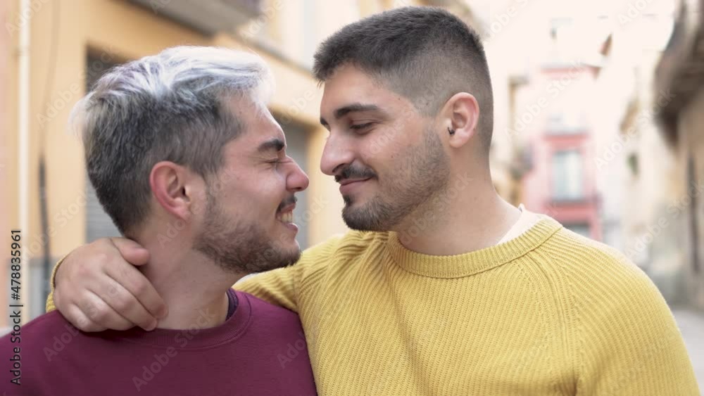 Gay male couple kissing outdoor in the city - LGBT love concept Gay male couple kissing outdoor in the city - LGBT love concept