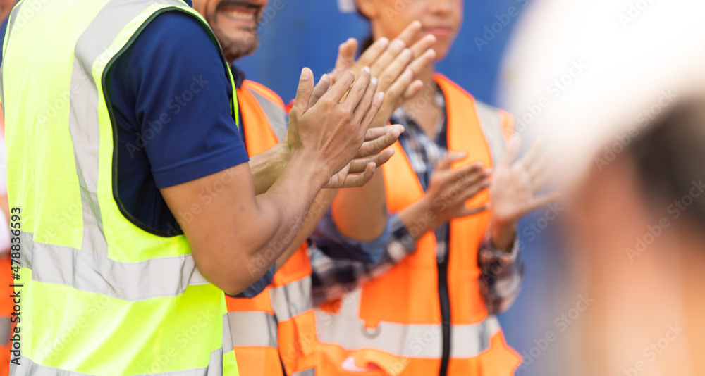 Fototapeta premium Unity and teamwork concept. Container worker audience applauding in morning brief meeting before going to work. Congratulation Celebrate success concept.