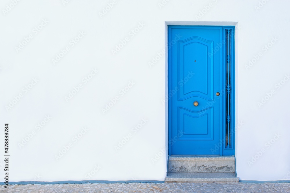 Simple blue door and pure white wall.