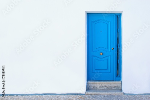 Simple blue door and pure white wall.