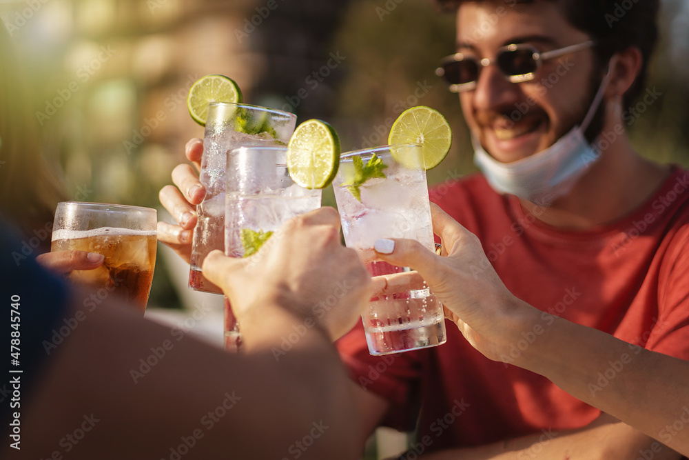 Friends party with young people wearing face masks gathering outdoors in new normal coronavirus time Friends party with young people wearing face masks gathering outdoors in new normal coronavirus time