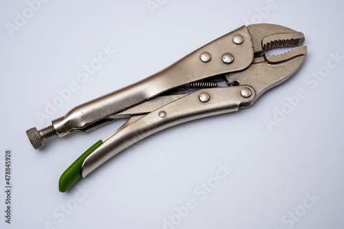 locking pliers on a white background. Artisan's hand tool close-up