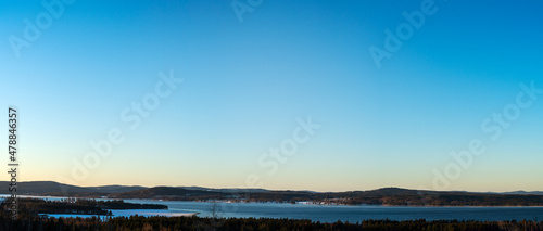 Sunrise over the mountains and lake Siljan on a cold morning. Winter landscape in Dalarna, Sweden. View from and photo taken at the village of Tällberg, Sweden. photo