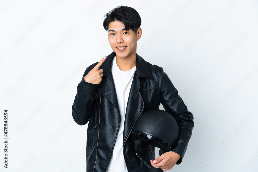 Chinese man with a motorcycle helmet isolated on white background giving a thumbs up gesture Chinese man with a motorcycle helmet isolated on white background giving a thumbs up gesture
