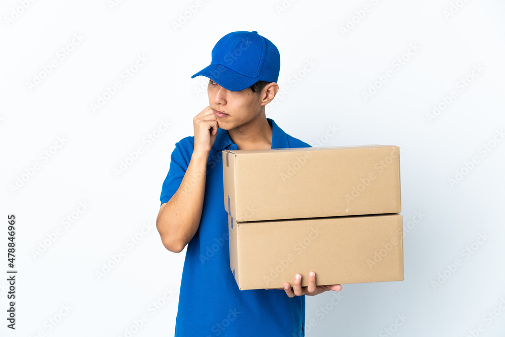 Delivery Chinese man isolated on white background with tired and bored expression Delivery Chinese man isolated on white background with tired and bored expression
