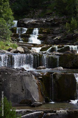 Waterfall in a landscape of rocks and vegetation
