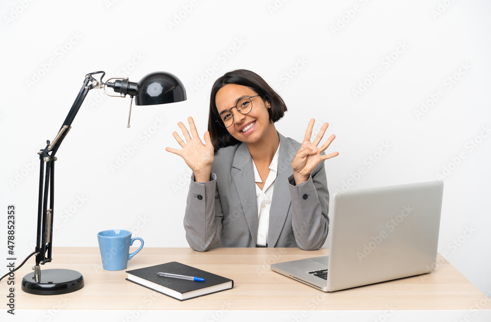 Young business mixed race woman working at office counting nine with fingers