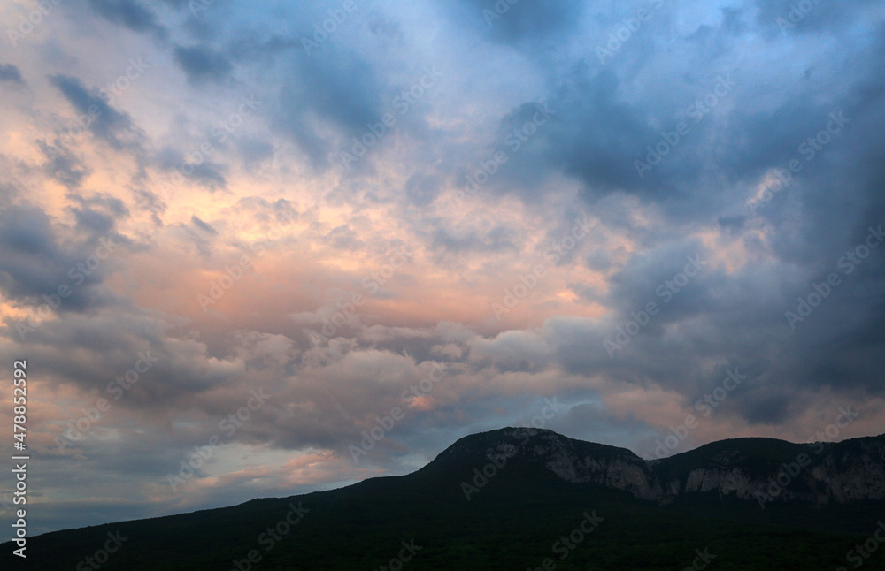 Beautiful clouds over mountains in the evening sky