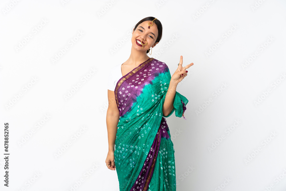 Young indian woman isolated on white background smiling and showing victory sign Young indian woman isolated on white background smiling and showing victory sign