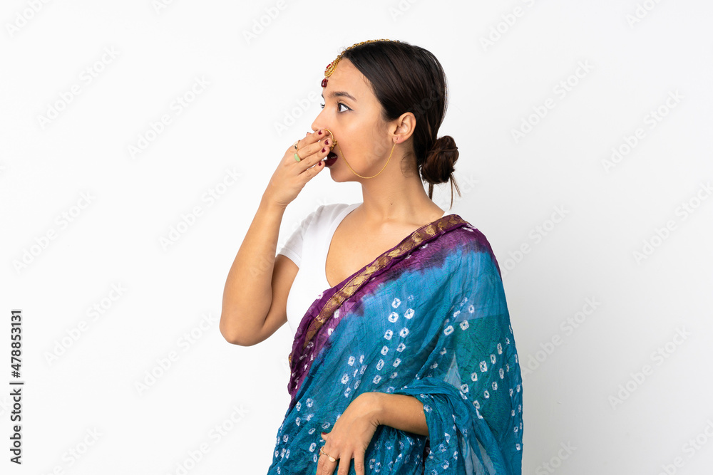Young indian woman isolated on white background doing surprise gesture while looking to the side Young indian woman isolated on white background doing surprise gesture while looking to the side