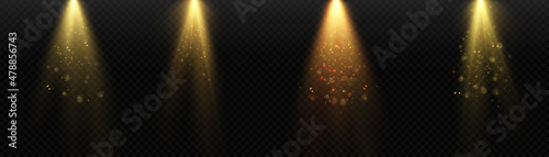 Stage light and gold glitter with the effect of golden rays, rays and sparkling dust falling on the floor. Vector.
