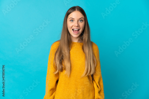 Young Lithuanian woman isolated on blue background with surprise facial expression