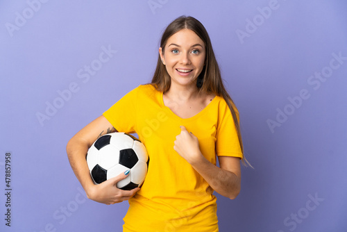 Young Lithuanian football player woman isolated on purple background with surprise facial expression © luismolinero