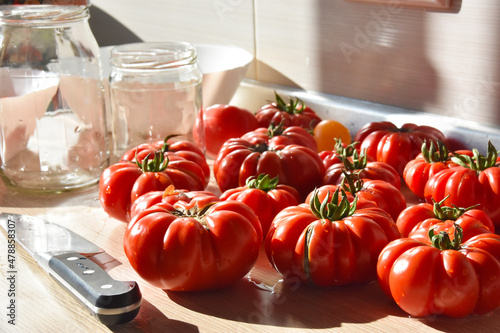 Beautiful Genovese ripe red tomatoes on the kitchen counter.