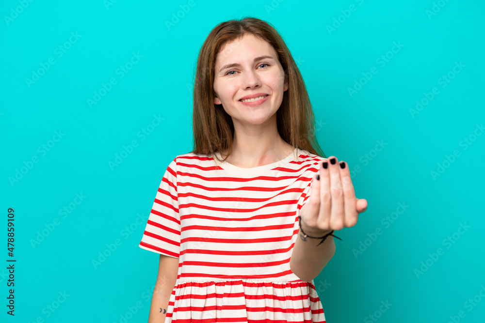 Young English woman isolated on blue background inviting to come with hand. Happy that you came
