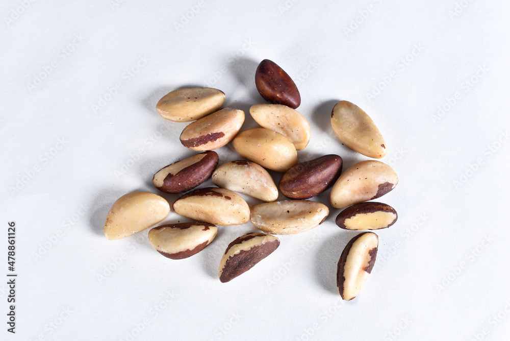 Brazil nuts on the white table, typical Brazilian fruit Brazil nuts on the white table, typical Brazilian fruit
