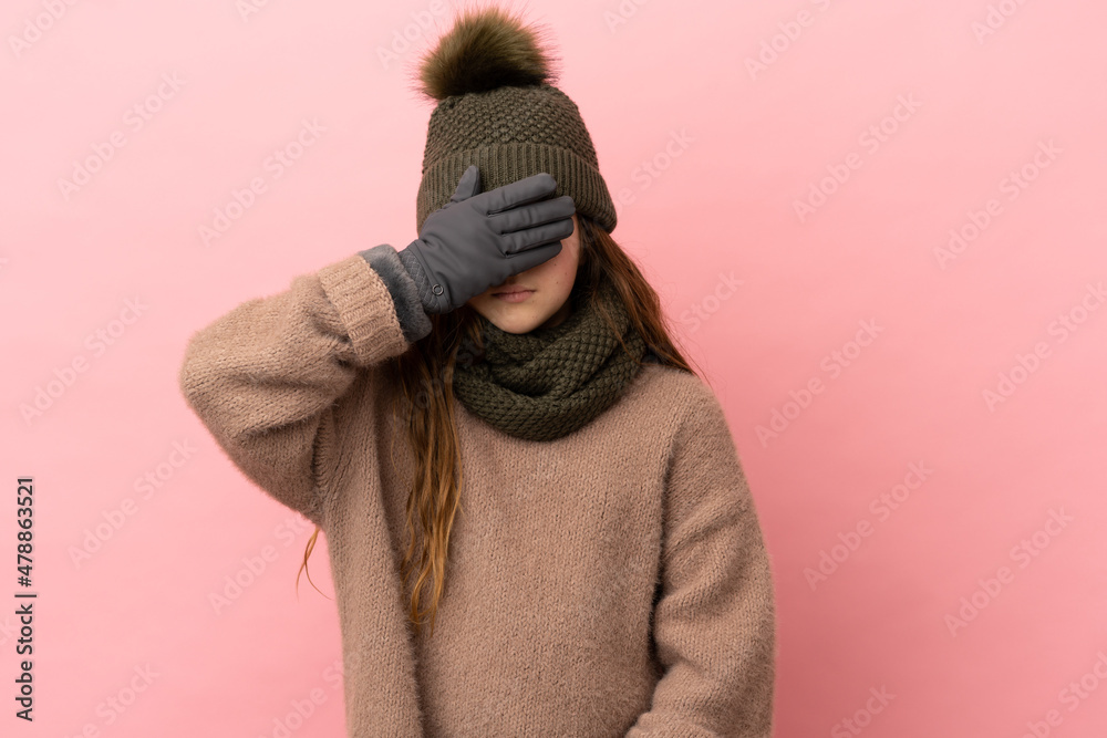 Little girl with winter hat isolated on pink background covering eyes by hands. Do not want to see something Little girl with winter hat isolated on pink background covering eyes by hands. Do not want to see something