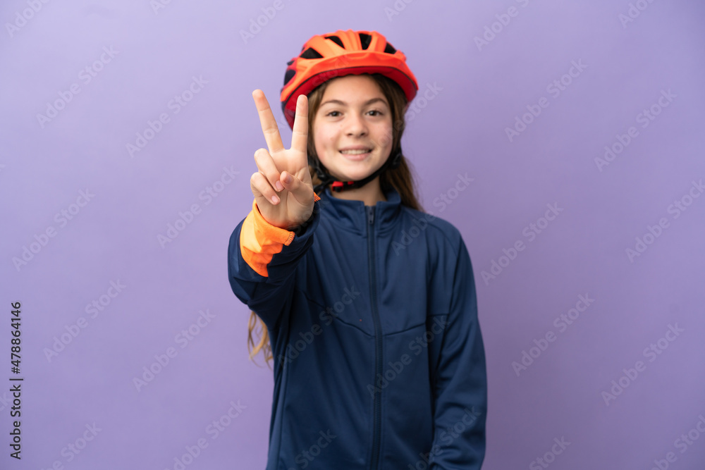 Little caucasian girl isolated on purple background smiling and showing victory sign Little caucasian girl isolated on purple background smiling and showing victory sign