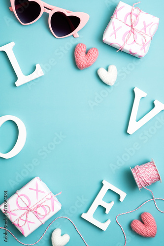 Happy Valentines Day concept. Blue vertical background with word love, gifts, sunglasses. Social media stories banner design.