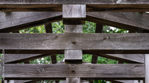 Abstract: Weathered Wooden Beams forming a Geometric Pattern