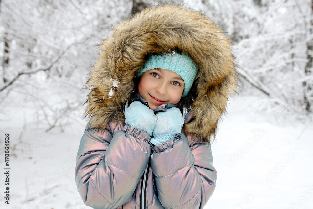 A girl in warm winter overalls on a walk in the winter forest: active games, playing snowballs and other activities A girl in warm winter overalls on a walk in the winter forest: active games, playing snowballs and other activities