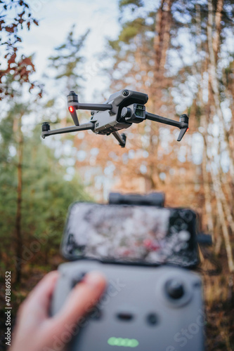 Flying drone in countryside in forest