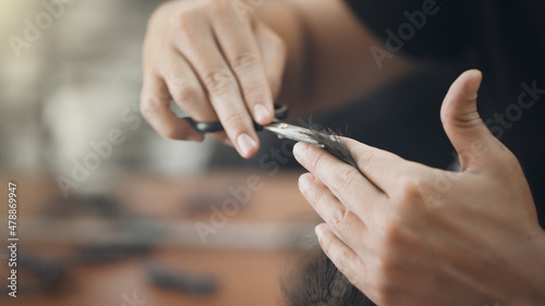Man with scissors while cutting hair