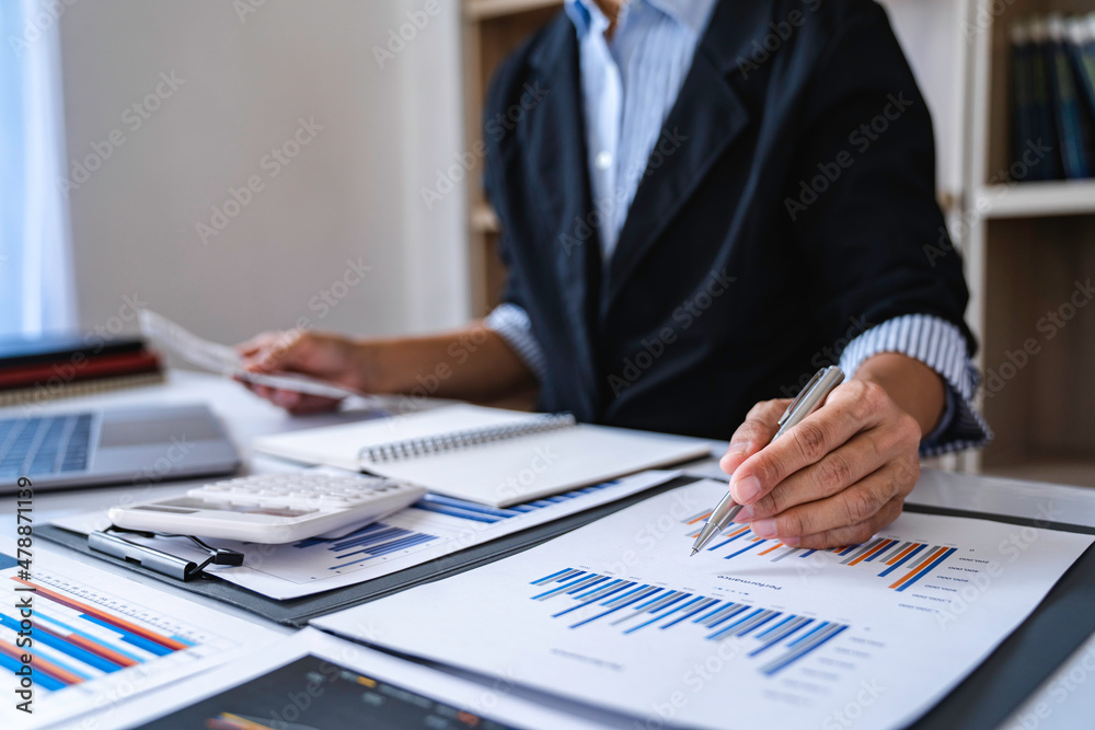 Close-up calculator to calculate the company's financial results On the wooden table in the office and business work background, tax, accounting, statistics, and analytical research concept Close-up calculator to calculate the company's financial results On the wooden table in the office and business work background, tax, accounting, statistics, and analytical research concept