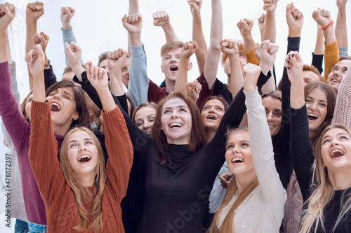 large group of friends standing with hands up