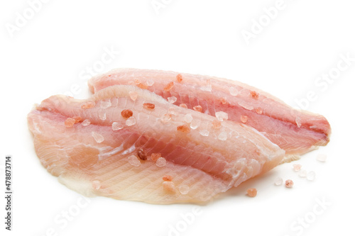 Prepared raw white fish fillet sprinkled with pink salt