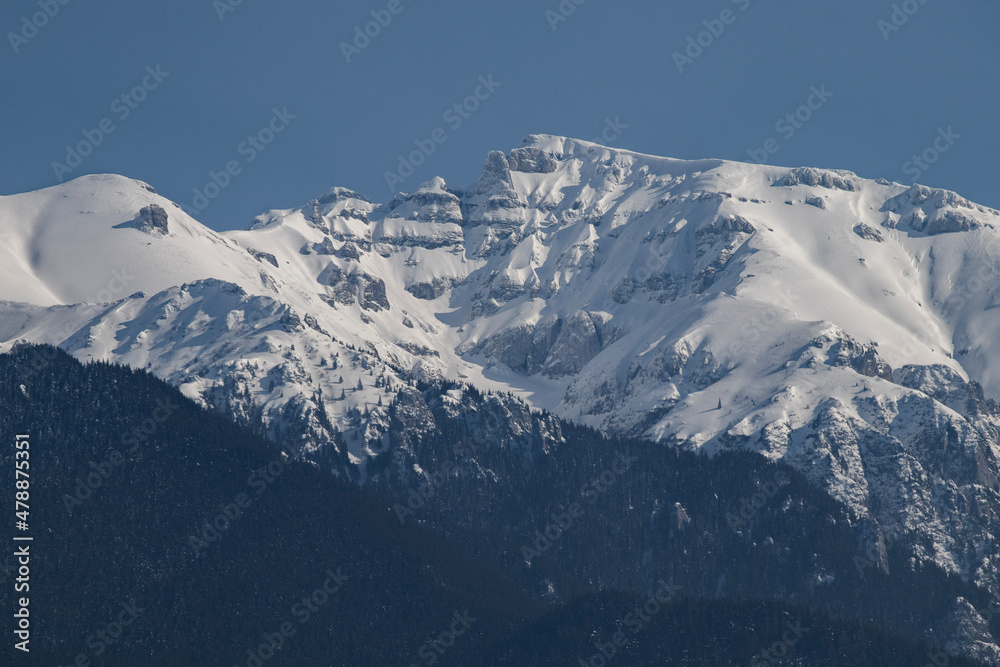 Bucegi Mountains seen from the city of Bran, Romania. Beautiful winter landscape. Part of the Carpathians Mountain Range.