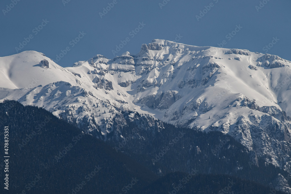 Fototapeta premium Bucegi Mountains seen from the city of Bran, Romania. Beautiful winter landscape. Part of the Carpathians Mountain Range.