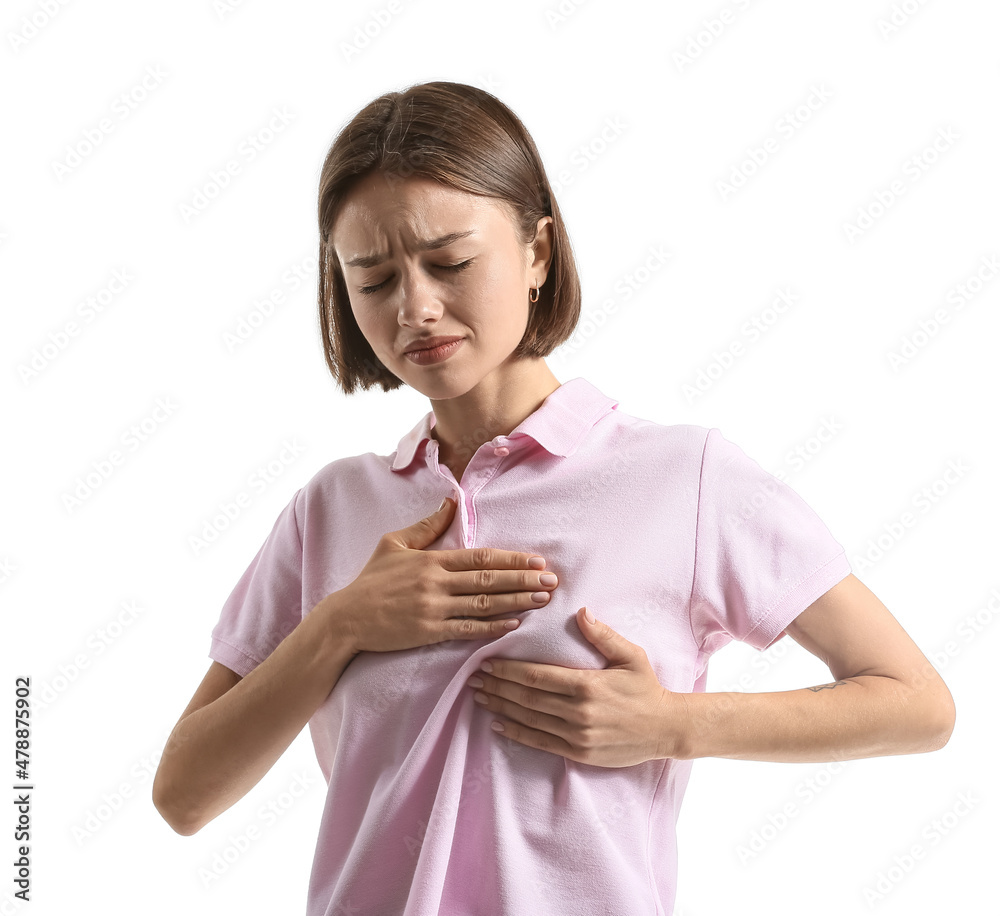 Young woman feeling discomfort in her breast on white background. Cancer awareness concept Young woman feeling discomfort in her breast on white background. Cancer awareness concept