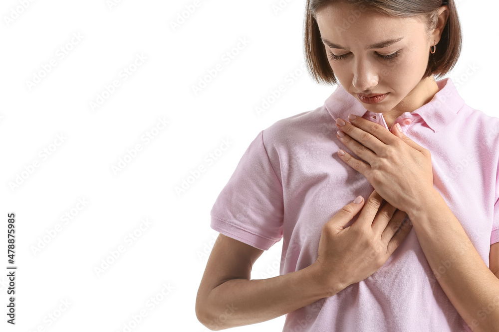 Young woman feeling discomfort in her breast on white background. Cancer awareness concept Young woman feeling discomfort in her breast on white background. Cancer awareness concept