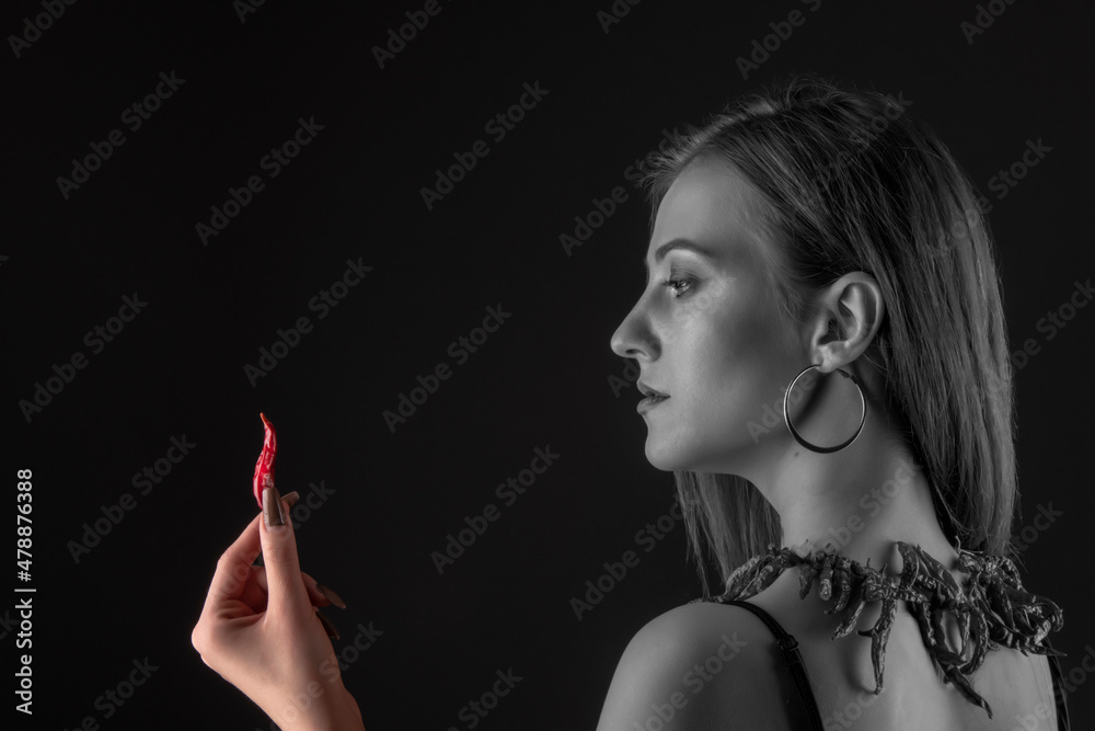 Obraz premium Beautiful Young Smiling Woman Holding Red Hot Chili Pepper.