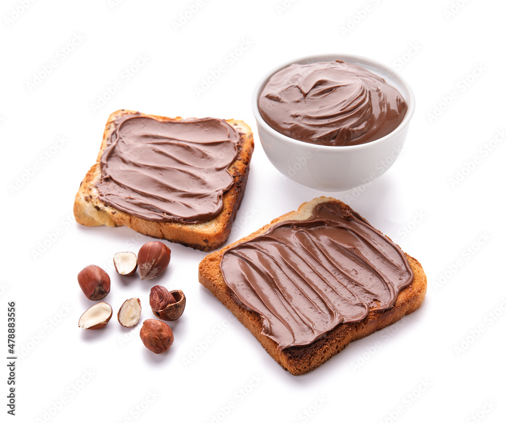 Bread with chocolate paste and hazelnuts on white background Bread with chocolate paste and hazelnuts on white background