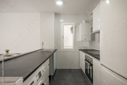 Kitchen with black countertop and recently installed bench furniture