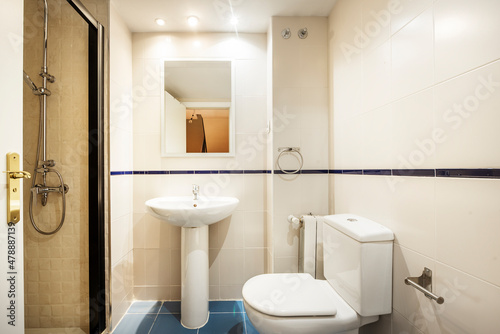 Conventional bathroom with shower and mirror in a vacation rental apartment