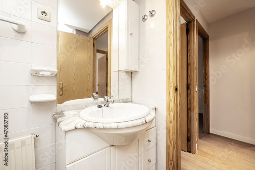 Toilet with white marble countertop and sink